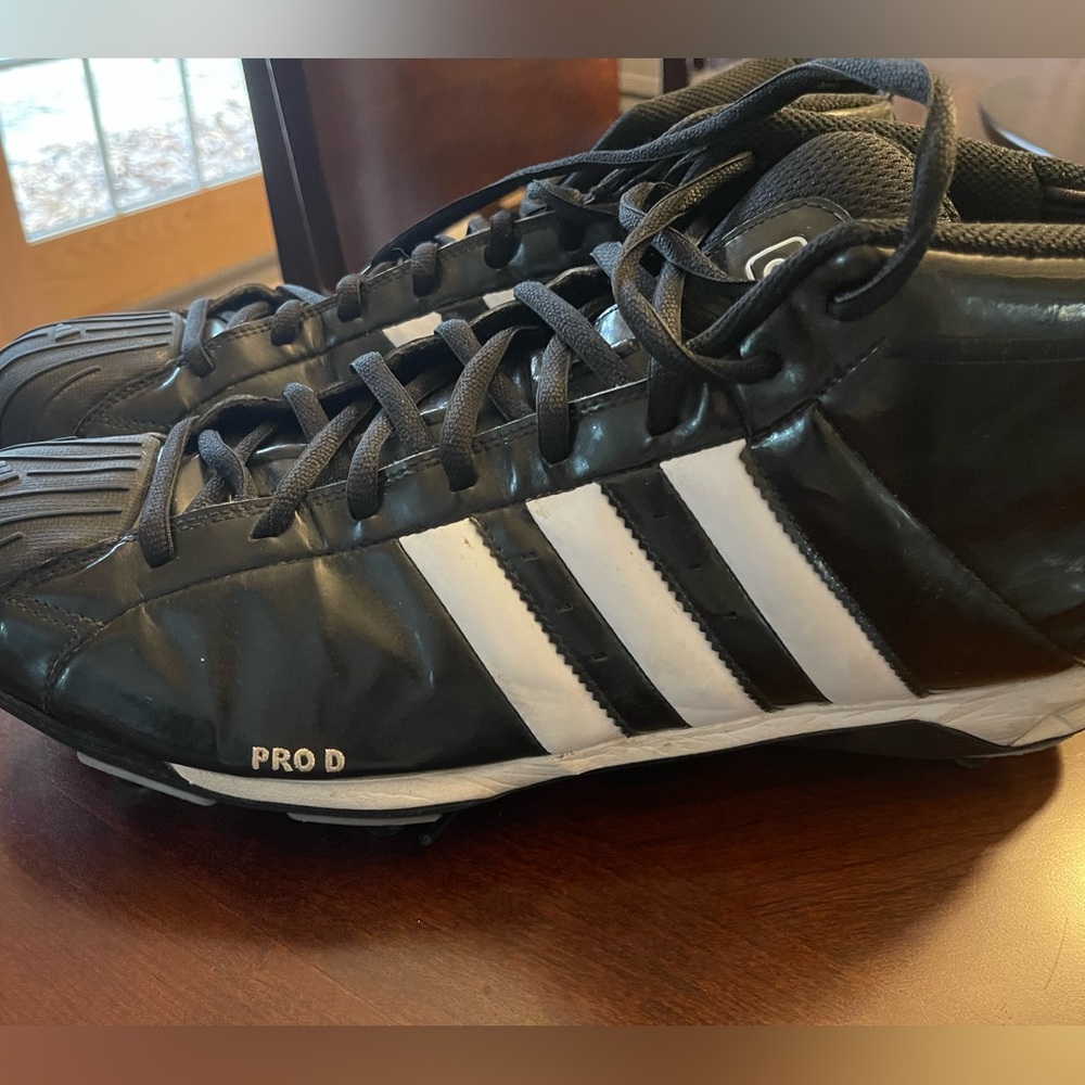 Men Adidas Pro D cleats for various sports.